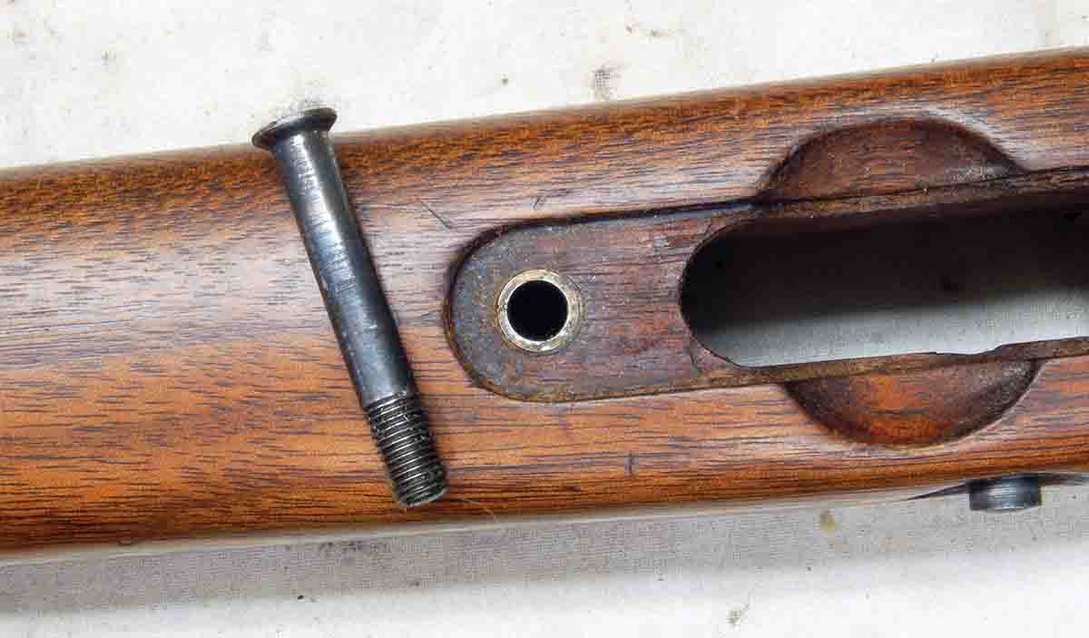 The earliest Model 52s are pillar bedded and held in the stock by only one guard screw. The other two screws in the trigger guard are wood screws.